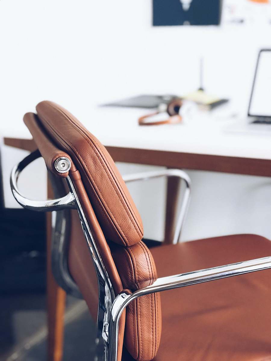office closeup photography of brown leather chair near white table greenville